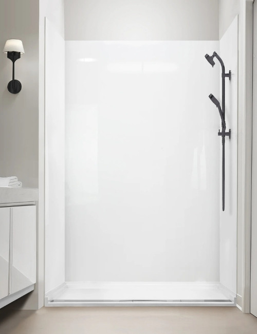Gloss white acrylic shower wall with matte black handheld and rail in a modern alcove