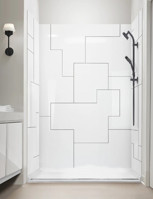 White shower wall with geometric panel lines and matte black handheld in a modern alcove